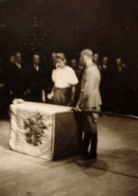 During a Sokol ceremony for new a new flag, Radka Křivánková knocks on the flag to honor her father's memory