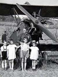 Jiří Langer / end of the war / Soviet biplane Kukuruznik on the field above Bořislavka / Jiří Langer in gray shorts / Prague / May 1945 
