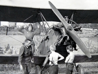 Jiří Langer / end of the war / Soviet biplane Kukuruznik on the field above Bořislavka / Jiří Langer in grey shorts / Prague / May 1945 