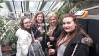 The student team on a tour of the orchid greenhouse