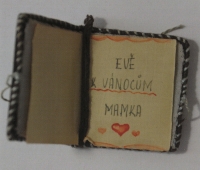 A small book, designed to be worn from the neck, made by her mother in the prison camp c. 1942. The witness received it by post for her seventh birthday. The prisoners were only allowed to send gifts that would fit into an envelope.