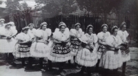 Marie in a folk costume with her friends, colorful folk costumes of unmarried girls
