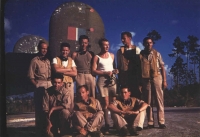 Evening at the Windsor Field base in Nassau. Standing, from the left: Karel Truxa, Ladislav Snídal, Josef Klesnil, Jan Irving (wearing a white tank top), Ilja Hrušák, an unknown man, probably British. Sitting, from the left: Karel Spitzkopf, Oskar Krebs, unknown Englishman
