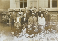 Rodina Lamplova před domkem proti synagoze, tatínkovi sourozenci s partnery a dětmi