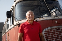 Wladyslaw Frasyniuk in front of a bus parked in front of the former Wroclaw depot that became the Centrum Historii Zajezdnia museum, August 2019.
