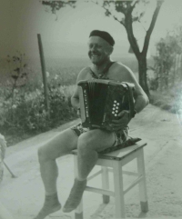 Playing an accordion in front of his native house in Horní Lapač