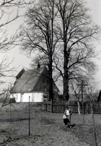 Karel Pexidr with his mother in front of the St. Ambrose church in Vícov; 1935  