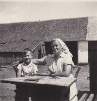 Václav Tuček with his grandmother Marie in the farmyard
