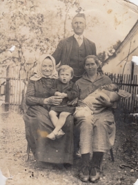 Before Kovář's mother's injury: sister Marie on her grandmother's lap, mother Anna Kovářová on the right with her little sister Zdena in her arms, father Kovář on the back (1928)