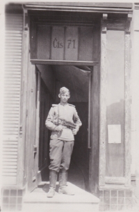 A soldier of the Red Army at the entrance to the Mucha´s house 
