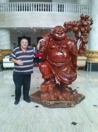 With the statue of Buddha