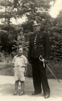 As a child with a police officer, Prague, 1941