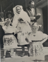 Irena Hlasicová with her granddaughter Danka infront of church in Čičmany