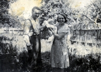 Newborn Milena with her parents in 1933