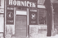 Mr Horníček’s butcher shop in Dolní Square in Humpolec, photographed during the Protectorate era when the German shop sign had to be on top and the Czech one below it
