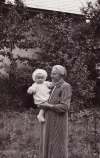 Helena Žďárská in her grandmother's arms 
