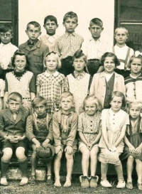 Charlotte Scharfová (sedí druhá zprava dole) v obecné škole v rodných Albrechticích, přelom 40. a 50. let 20. století 