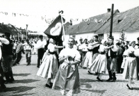 Jana is carrying the banner in the middle, with the folklore ensemble in Strážnice, 1959