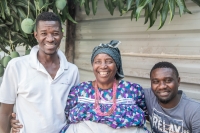 Josephine today, standing with two boys from the group, Saltiel (left) and Little John