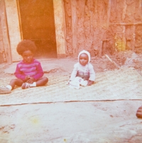 Oye (left) in an exile camp