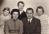 With his parents and sisters 
