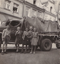 Memoirist (third from right) with friends in front of Soviet equipment, 1945
