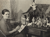 Rozálie Schwarzerová (1907-1987) maluje figurky do betlému, které vyřezal její manžel Josef