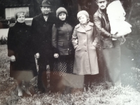 Father Svinolupov holding Oksana in a swaddle, his wife Natasha in the middle, grandfather Minin on the left, 1980
