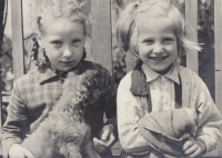 Marie Šlechtová (with a dog) and her younger sister Ivana in Čachovice around the beginning of the 1960s