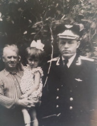 Natalia in the arms of grandfather Mikhail who was injured in the war (aged 45 in the photo), with Natalia’s father next to him, Kuban, 1958