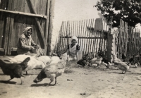 Mom and grandma with poultry in the backyard of their farm