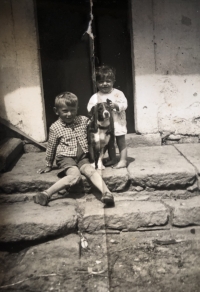 Siblings with their dog on the porch of the house, late 1930s