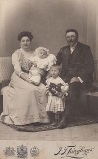 His grandmother Marie Kučerová and grandfather Jan Kučera, the small child is his uncle Josef, the bigger child is his mother Marie, Langhans, Hradec Králové, 1910