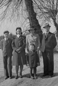 The Máca family, foster family of the witness's father, who is standing in the foreground, at the end of World War II