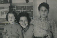 With her brother and mum, 1957
