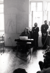 Opening of Milan Knížák's exhibition at Sovinec, 1986-1987, in the background on the right stands Jindřich Štreit