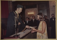 Mária and receiving her diploma (completion of university studies).

