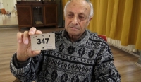 Jiří Hála showing the accommodation ticket to Ponávka where the family lived before deportation to Terezín, December 2023