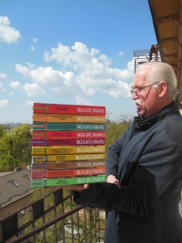 Vasyl Gabor holding Halyna Pahutyak's ten-book series. Lviv, 2023