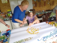 Nataliia Haidai with her daughter at the camp for children with mental disabilities in Prymorske village (Kherson region), 2021