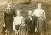 Rodinný snímek prarodičů Šromových z Mikolajic s dětmi. Úplně vlevo matka Jiřího Jaroše Marie, nejmenší uprostřed dole je strýc Oldřich, který pracoval v opavském pivovaře, a vpravo strýc Max, který pracoval v opavském podniku Minerva. Vpravo nahoře je matčina sestra Cyrila. Fotografie z počátku 20. let. 20. století