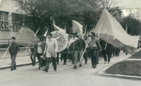 Juraj Kuzma as a young man with a flag in the May Day parade (in the photo on the left)