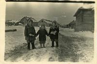 At time of exile. Children of Fr. Markiyan Mykytky in front of barracks - Lyubomyra, Orest, and Aniziya. Special settlement Kuchi, Khabarovsk krai 1953.