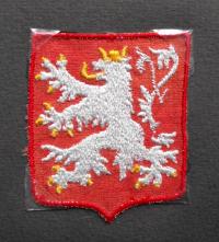 Malý státní znak z Annina oděvu, který nosila v pracovním táboře, 1943 - 1945