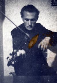 Scout leader Jaroslav Kocich-Tája playing a violin