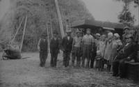 A group photograph with a threshing machine during harvest in summer 1933