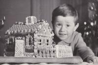 With a gingerbread house, which my granny used to baked each winter; photo taken following my fourth birthday in January 1971 (the motive repeats in the album, which my dad was created all through my childhood)