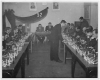 Father Milutin Rajkovich playing simultaneous chess, 1952