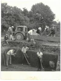 In job (behind the tractor)