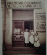 The witness with her parents in front of a sweet shop in Mukachevo
